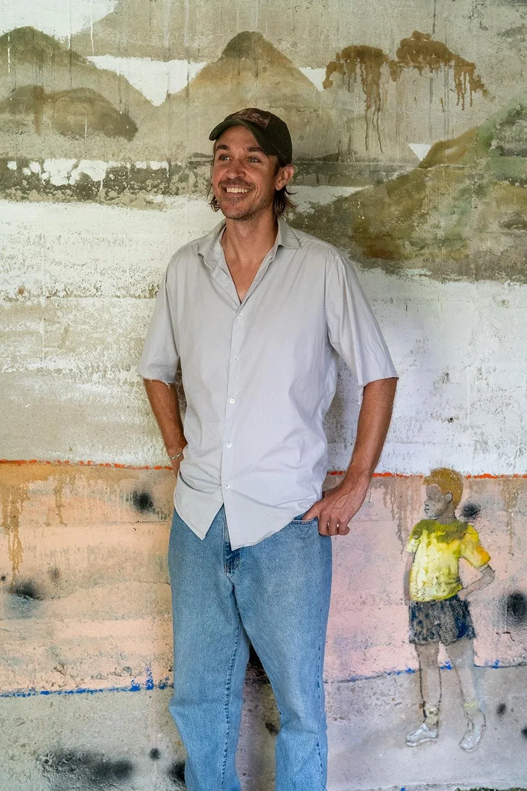 Casey Bolding standing in front of a painted wall