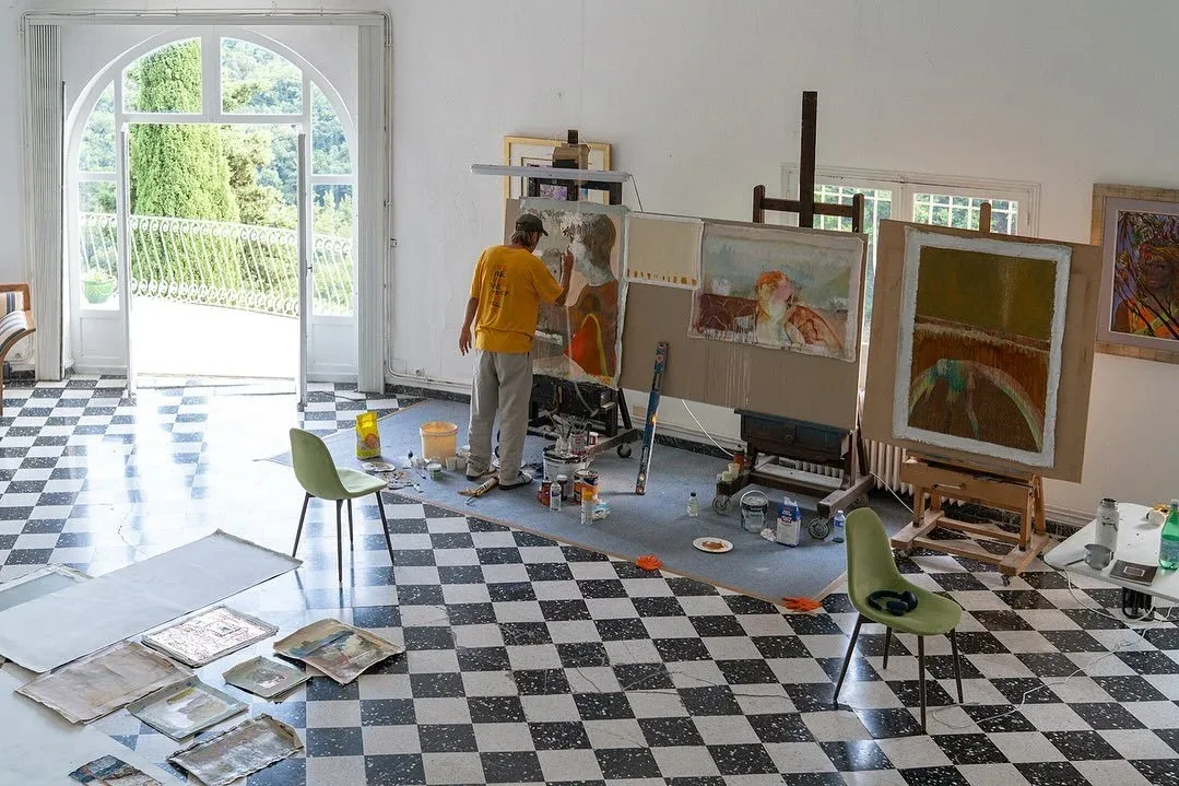 Casey Bolding painting in the salon at Castel Caramel