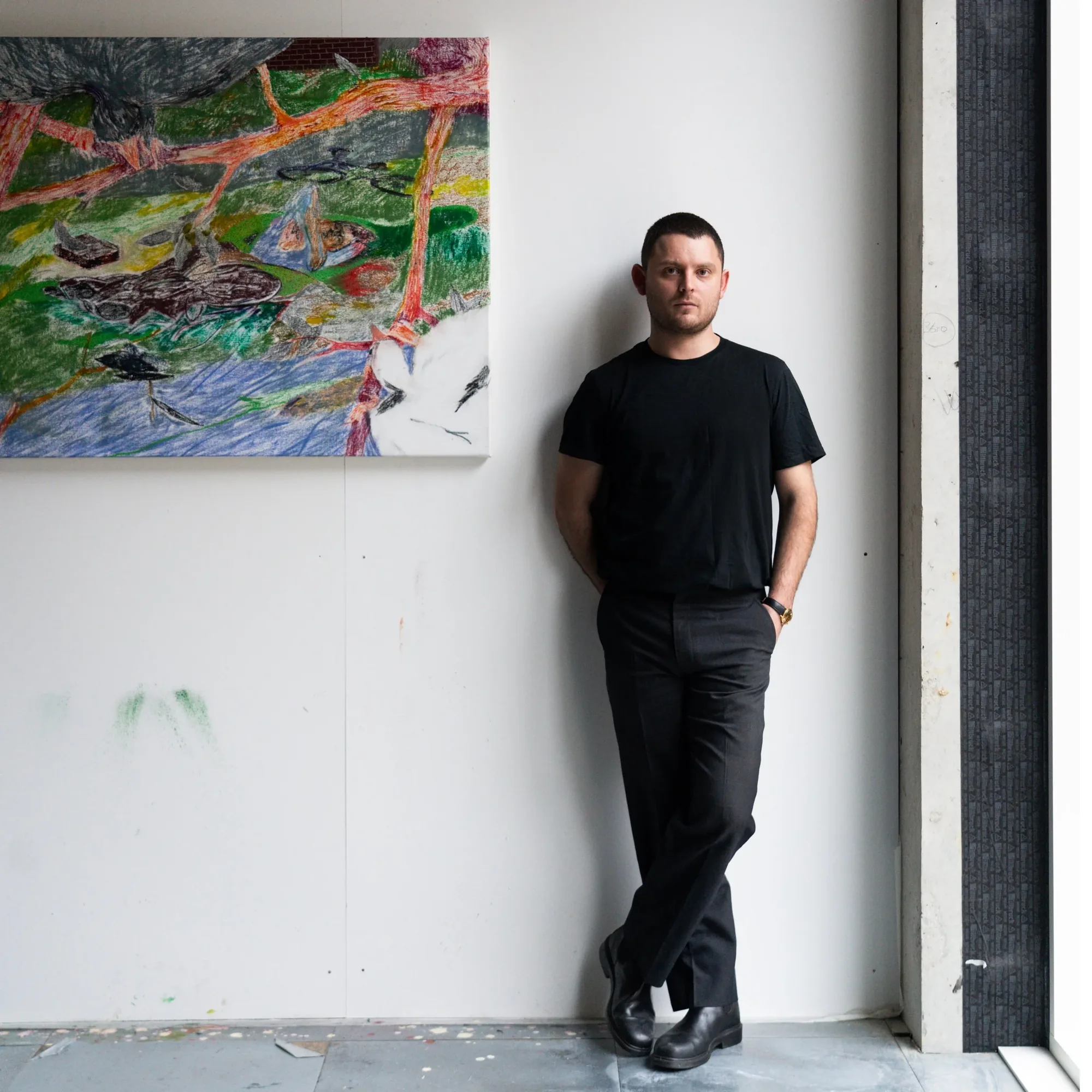 Henry Curchod standing beside one of his paintings