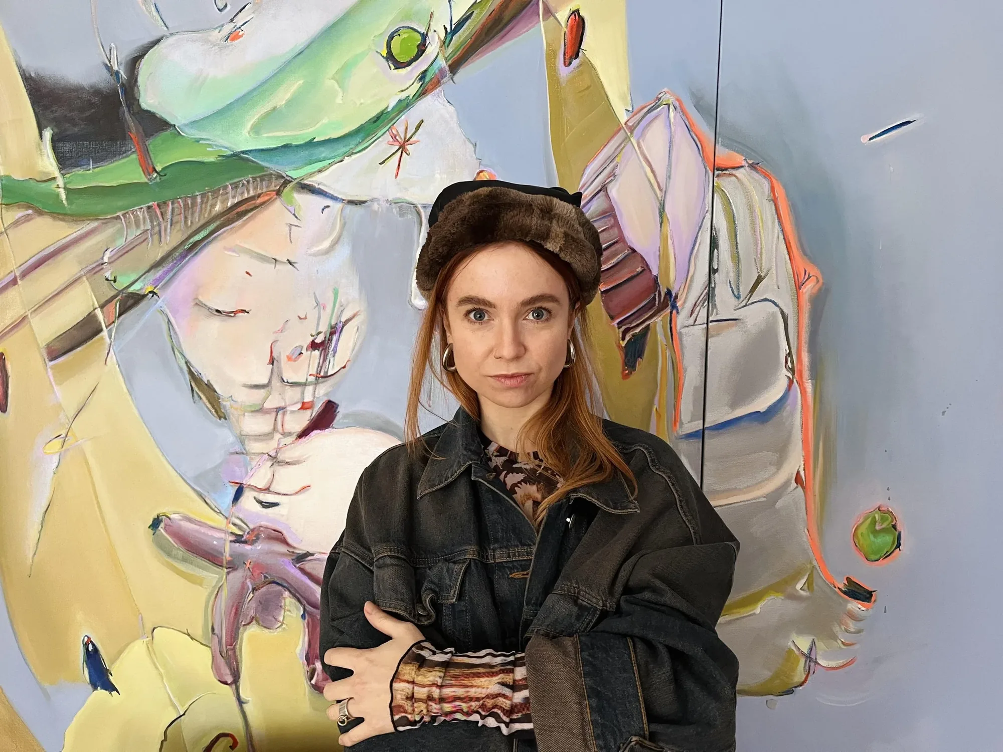 Stefanie Heinze in front of one of her paintings
